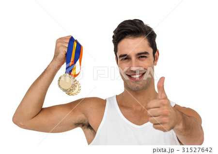 Athlete posing with gold medals 31527642