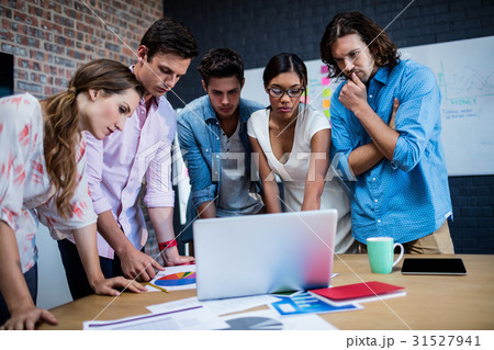 Group of designers working on a computer 31527941