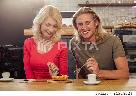 Couple eating a cake togheter Couple eating a cake togheter 31528523