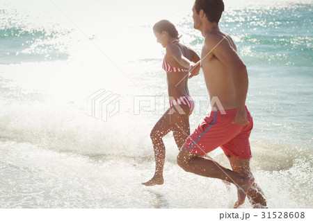 Couple running in water Couple running in water 31528608