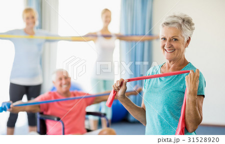 Seniors exercising with stretching bands Seniors exercising with stretching bands 31528920