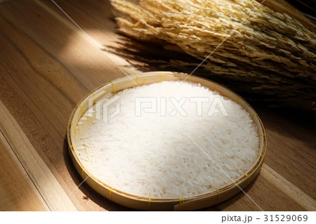 Paddy and white rice on wooden background. 31529069