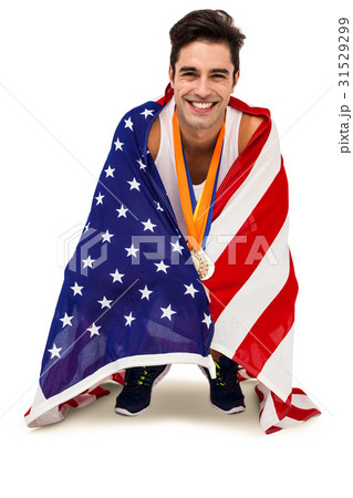 Athlete with gold medals around his neck wrapped in american flag 31529299