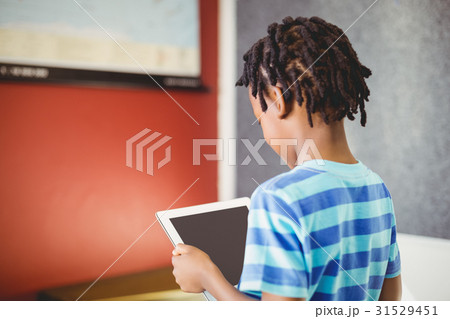 Schoolboy using digital tablet in classroom 31529451