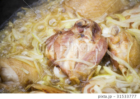 Cooking meat outdoors in a iron cauldron. Cooking 31533777