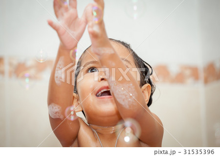 Child little girl bathing and playing with bubble Child little girl bathing and playing with bubble 31535396
