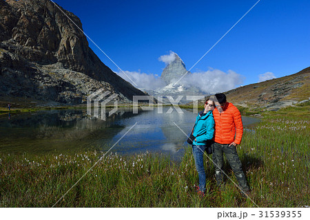 asian couple smiling  in front of Riffelsee lake  31539355