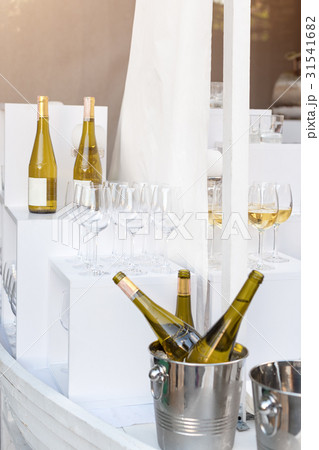 Bottles of white wine standing on serving table Bottles of white wine standing on serving table 31541682