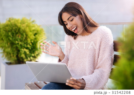 Friendly genuine woman making a video call 31542208