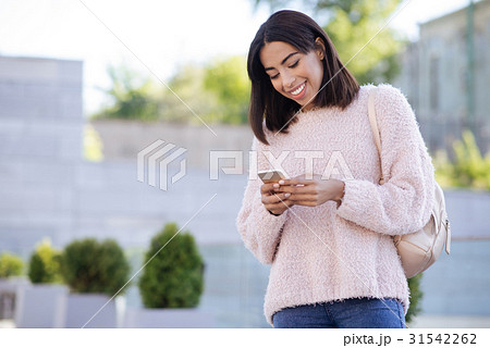 Charming cheerful girl checking her email 31542262