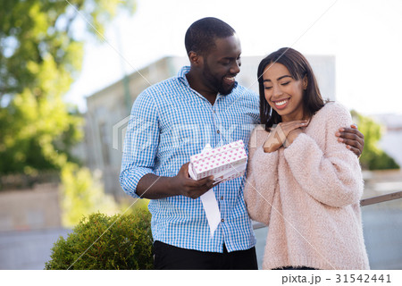 Gallant creative guy receiving a surprise gift Gallant creative guy receiving a surprise gift 31542441