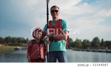 Man and boy posing with oar 31544097