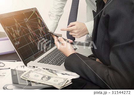 business hand point on a laptop with Stock trade business hand point on a laptop with Stock trade 31544272