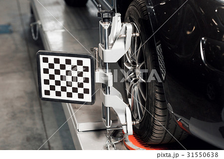 Car on stand with sensors wheels for alignment 31550638