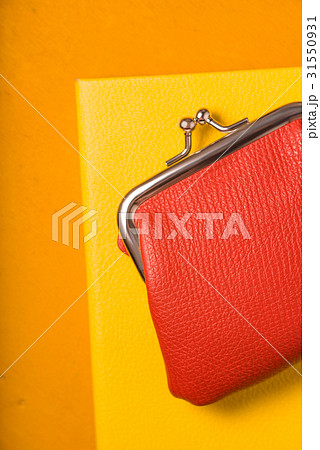 Orange purse with notebook on bright background 31550931