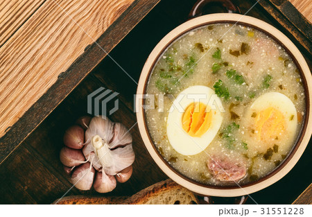 White sour soup with sausages and eggs. White sour soup with sausages and eggs. 31551228