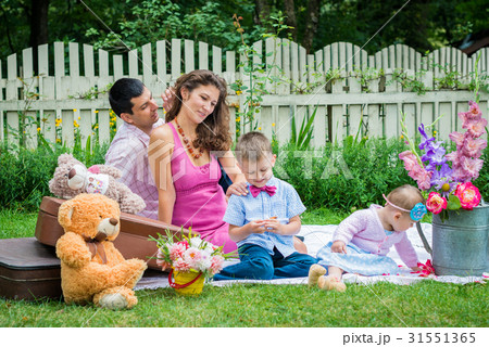 A couple sitting with the children A couple sitting with the children 31551365