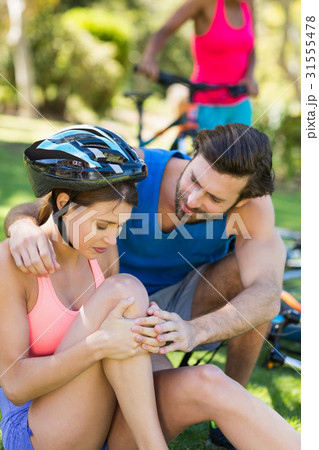 Man looking after injured woman Man looking after injured woman 31555478