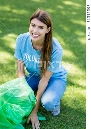 Portrait of volunteer woman collecting rubbish Portrait of volunteer woman collecting rubbish 31555598
