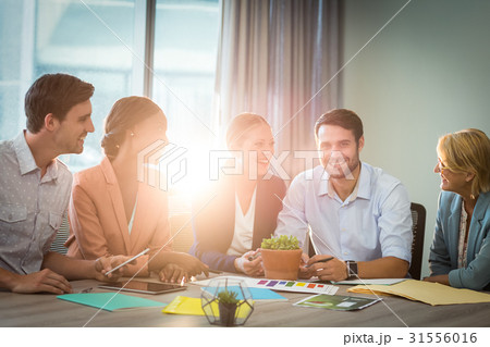 Group of business people discussing at desk 31556016