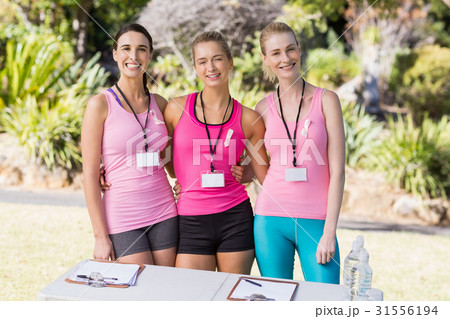 Happy female volunteer standing in park 31556194