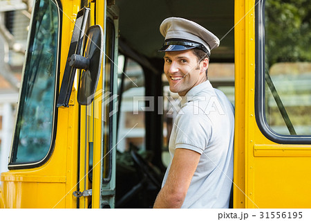 Bus driver smiling while entering in bus 31556195