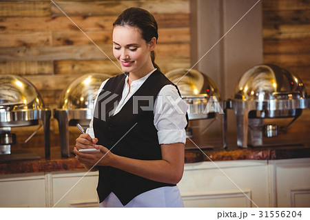 Waitress taking order on a notebook Waitress taking order on a notebook 31556204