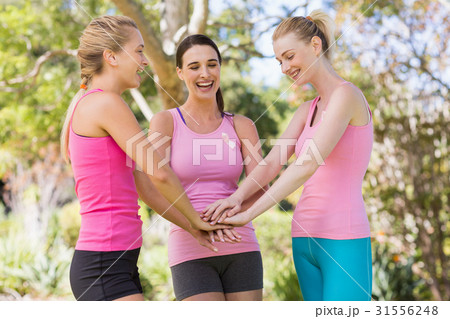 Young volunteer women forming hands stack 31556248