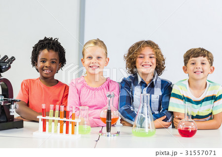 Portrait of kids doing a chemical experiment in laboratory Portrait of kids doing a chemical experiment in laboratory 31557071