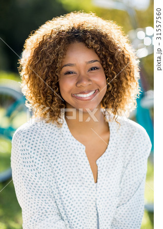 Happy woman sitting in park Happy woman sitting in park 31557560
