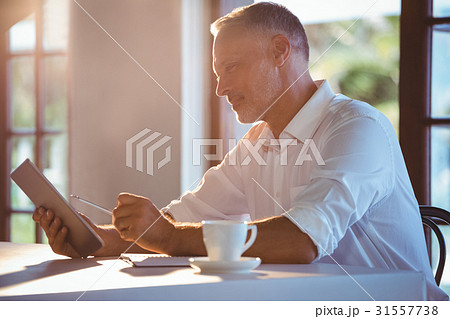 Man using tablet and notebook Man using tablet and notebook 31557738