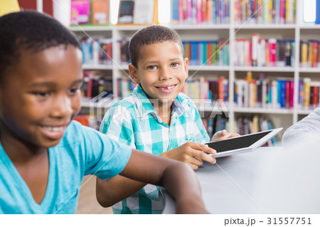 Kids using digital tablet in library 31557751