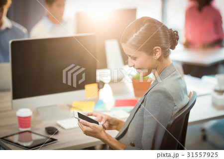Businesswoman using mobile phone 31557925