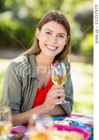 Portrait of woman holding wine glass and smiling 31557970