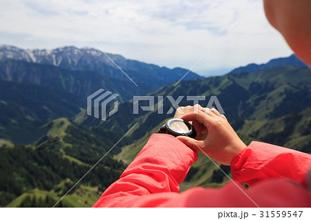 Woman hiker checking the altimeter 31559547
