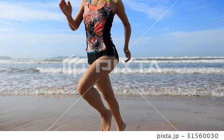 young fitness woman running to the sea young fitness woman running to the sea 31560030