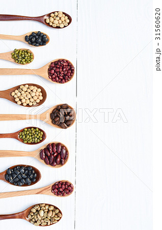 Assortment of beans and lentils in wooden spoon Assortment of beans and lentils in wooden spoon 31560620