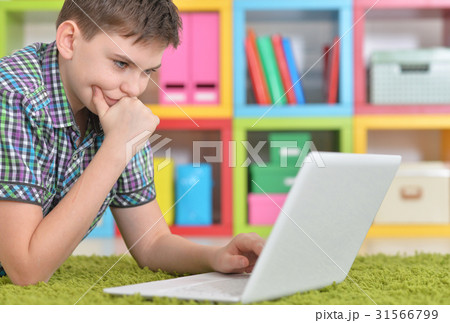 Teenage boy with a laptop Teenage boy with a laptop 31566799