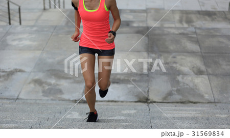 young fitness woman running up on stone stairs young fitness woman running up on stone stairs 31569834