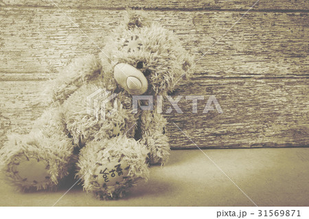 Cute teddy bear on brown wooden background Cute teddy bear on brown wooden background 31569871