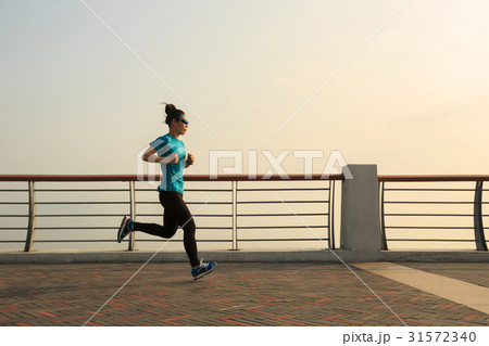 Healthy lifestyle concept, young woman running at seaside 31572340