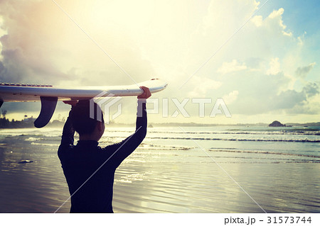 young woman surfer with surfboard ready to surf 31573744