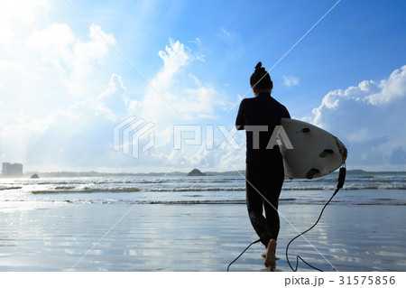 young woman surfer with surfboard ready to surf on a beach young woman surfer with surfboard ready to surf on a beach 31575856