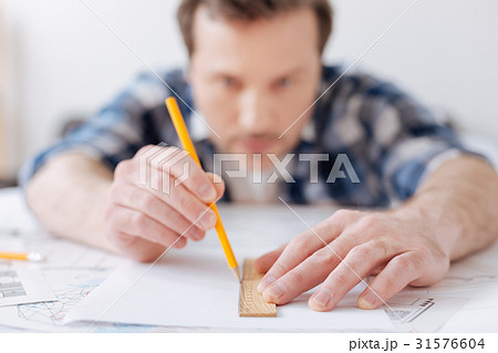 Close up photo of male hands while drawing plan Close up photo of male hands while drawing plan 31576604