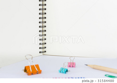 note book and paper clips on white background 31584480