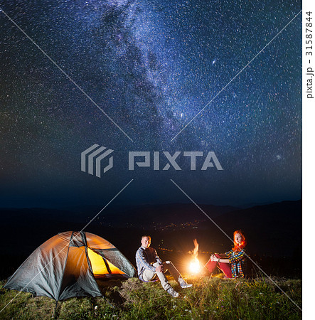 Tourists in camping at night against starry sky 31587844