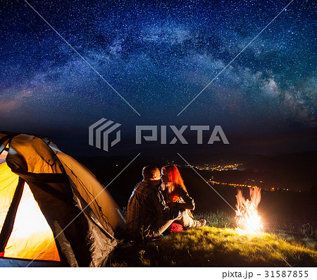 Tourists in camping at night against starry sky 31587855