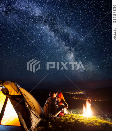 Tourists in camping at night against starry sky 31587856