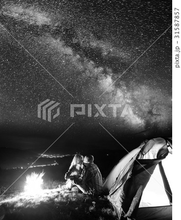 Tourists in camping at night against starry sky Tourists in camping at night against starry sky 31587857