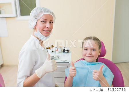 Happy child in dentist chair with female doctor Happy child in dentist chair with female doctor 31592756